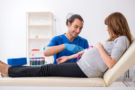 Young pregnant woman in blood transfusion conceptの写真素材