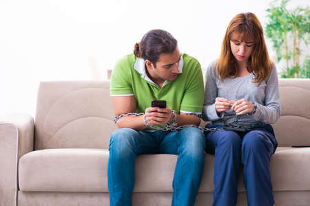 Young couple in gadget dependency conceptの写真素材