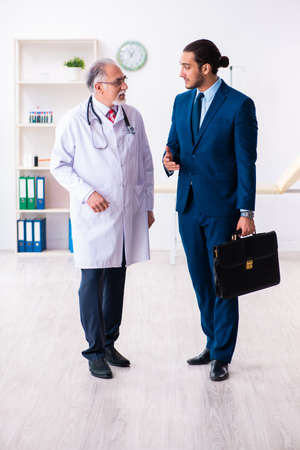 Male doctor and businessman discussing medical projectの写真素材