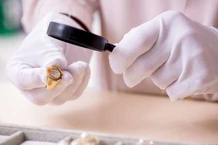 Old male jeweler at workshopの写真素材