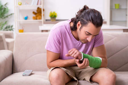 Injured young man at homeの写真素材