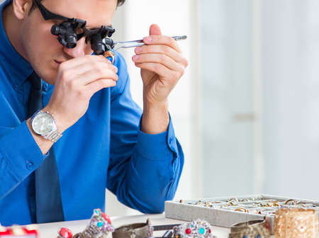 The jeweler working with luxury jewelry in the workshop