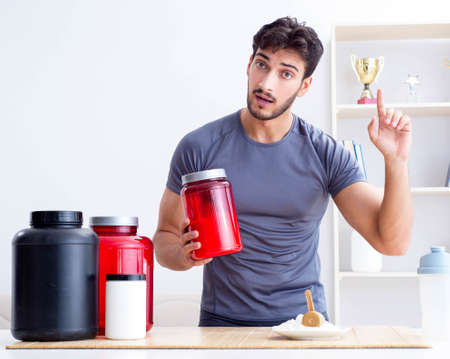 Athlete tasting new protein supplements for better musclesの写真素材