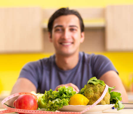 Young man in dieting and healthy eating conceptの写真素材