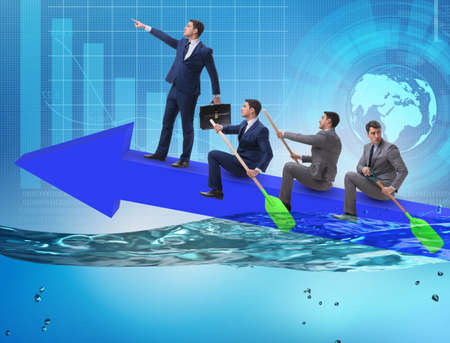 Teamwork concept with businessmen on boatの写真素材