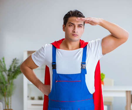 Super hero repairman working at homeの写真素材
