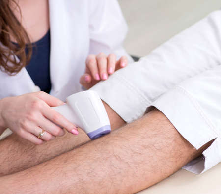 Young man visiting doctor for epilationの写真素材