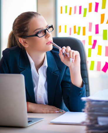 Beautiful female employee with many conflicting prioritiesの写真素材