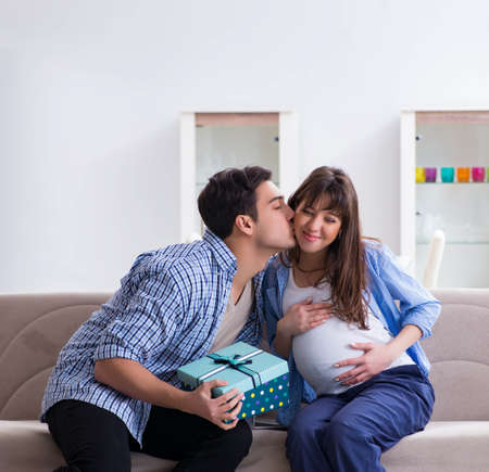 Happy family celebrating pregnancy at homeの写真素材