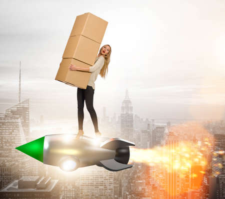 Woman in fast box delivery service on rocketの写真素材
