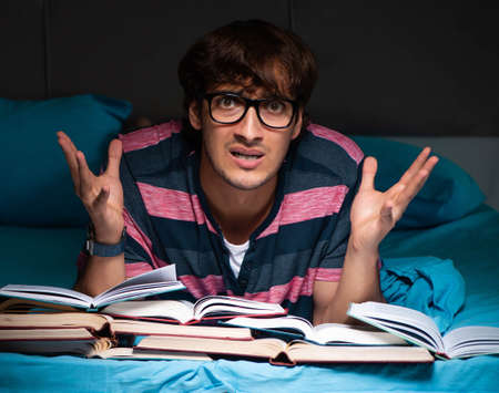 Young student preparing for exams at night at homeの写真素材