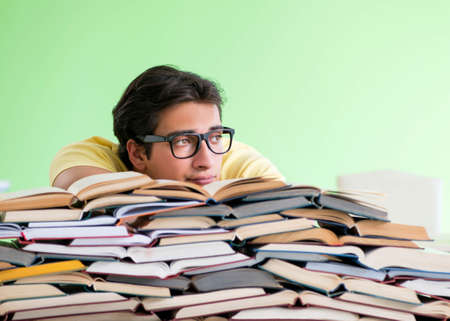 Student with too many books to read before examの写真素材
