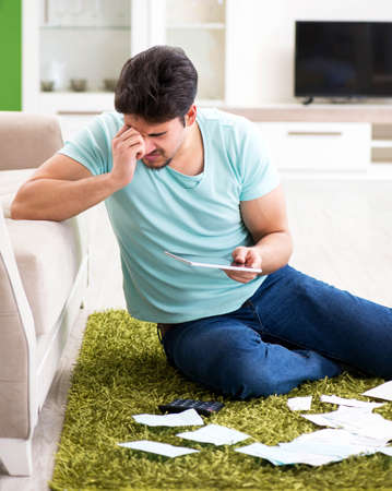 Young man struggling with personal finance and bills
