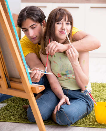 Young couple enjoying painting at homeの写真素材