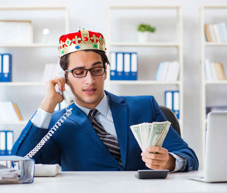 Businessman king with money in the officeの写真素材