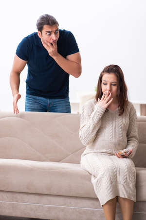 Man and pregnant woman in antismoking conceptの写真素材