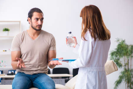 Male diabetic patient visiting young female doctorの写真素材