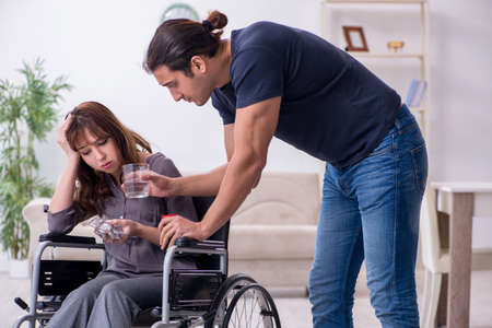 Disabled wife and young husband at homeの写真素材
