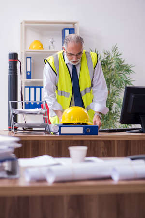 Old male architect working in the officeの写真素材