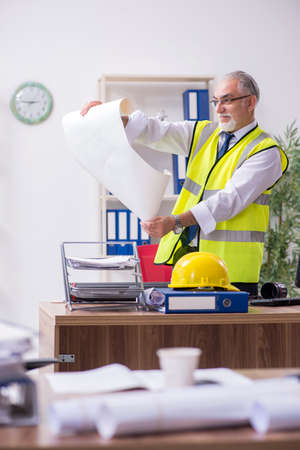 Old male architect working in the officeの写真素材