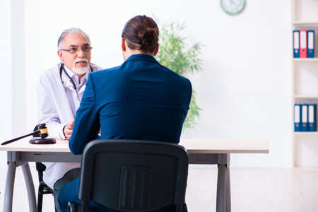 Male doctor in courthouse meeting with lawyerの写真素材