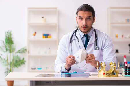 Doctor working in lab in coronavirus COVID-19 conceptの写真素材