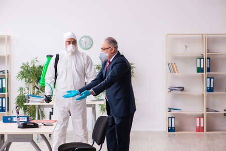 Old employee and young contractor in coronavirus conceptの写真素材