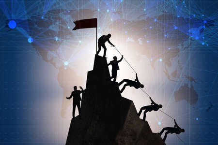 Concept of teamwork with team climbing mountain