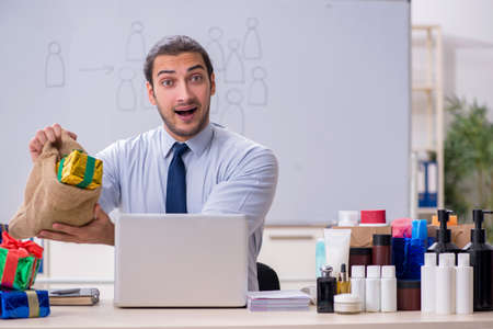 Young male shopaholic in e-commerce conceptの写真素材
