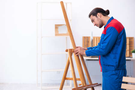 Young male contractor working in workshopの写真素材