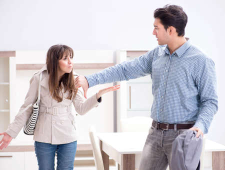 Young couple disappointed with price in furniture storeの写真素材