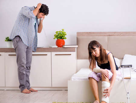 Caring husband looking after his injured wifeの写真素材