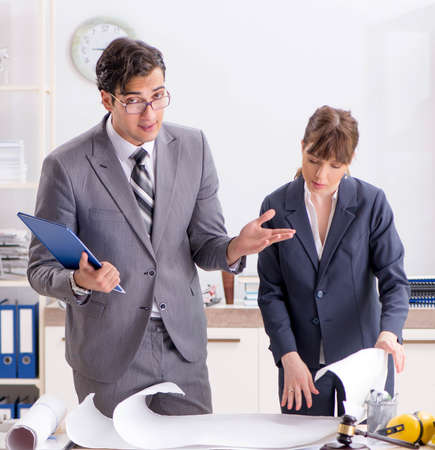 Man and woman discussing construction projectの写真素材