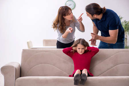 Young couple and their daughter in family conflict conceptの写真素材