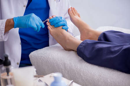 Podiatrist treating feet during procedureの写真素材