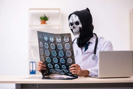 Male devil doctor radiologist working in the clinic