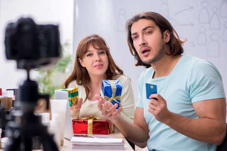 Young couple sales consultants recording video for their blog