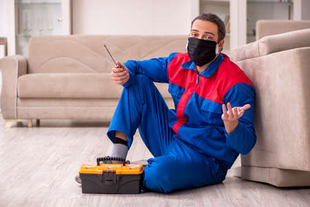 Young carpenter working indoors during pandemic diseaseの写真素材