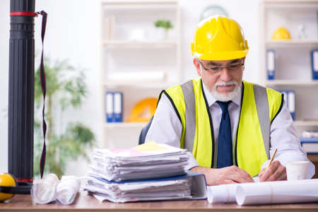 Old male architect working in the officeの写真素材