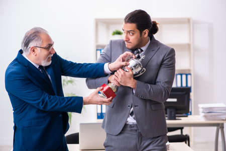 Two male employees working in the officeの写真素材