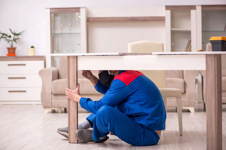 Young carpenter working indoors during pandemic diseaseの写真素材