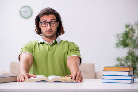 Young male student preparing for exams at homeの写真素材