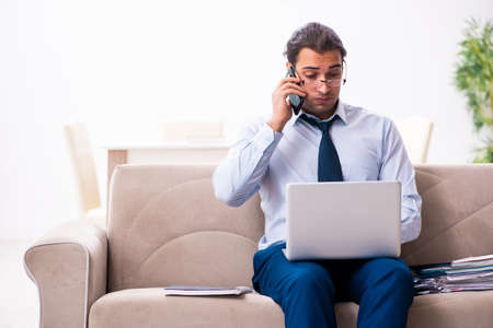 Young male employee working from houseの写真素材