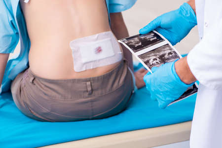 Injured young woman visiting young male doctor