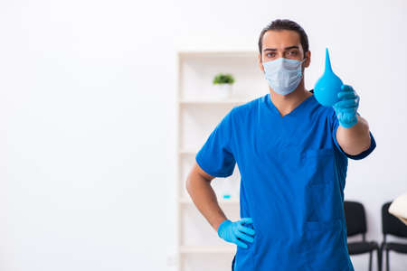 Young male doctor working in the clinicの写真素材