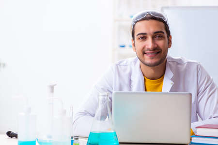 Young male chemist student preparing for examの写真素材