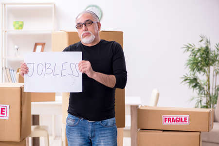Old male professional mover doing home relocation