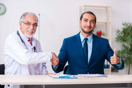 Male doctor and businessman discussing medical projectの写真素材