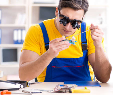 Computer repair technician repairing hardware