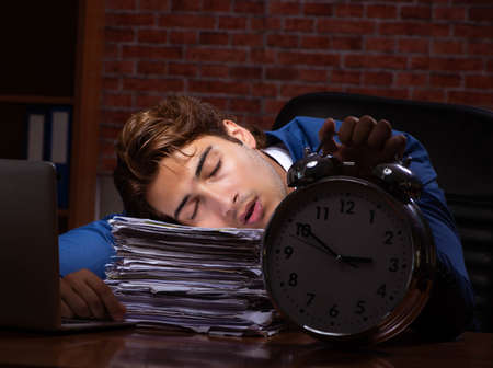 Young businessman working in the office at night